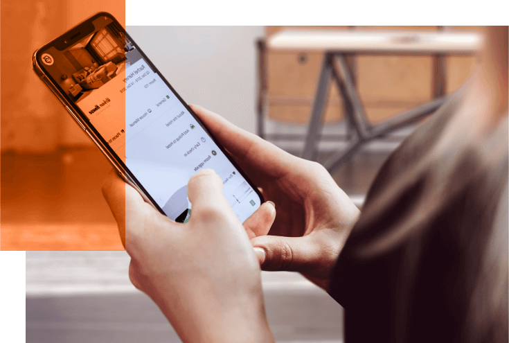 woman holding a mobile phone and booking a hotel room