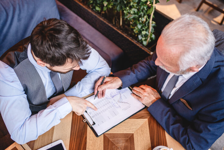 yield management. Businessmen analyzing financial reports