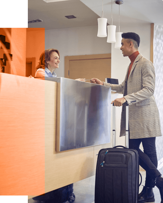 smiling receptionist at hotel desk