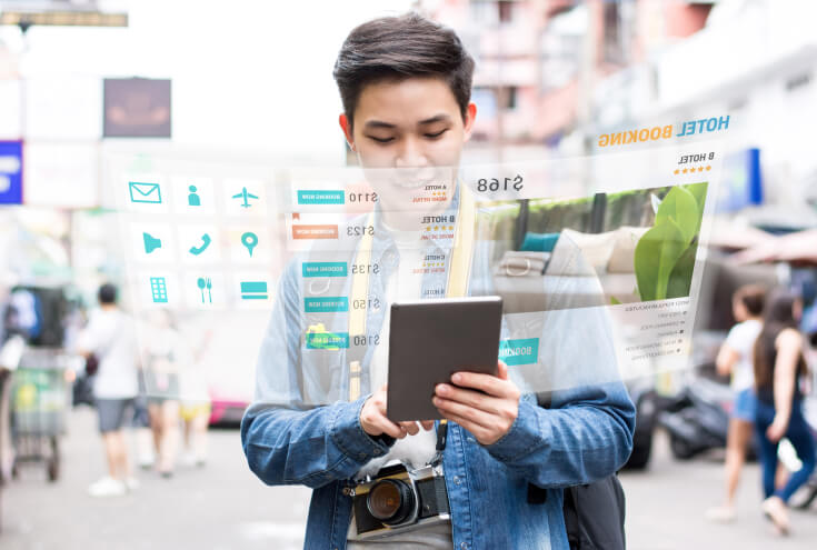 Asian tourist using mobile application technology booking hotel online