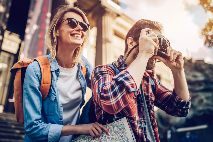 happy tourist couple taking a picture