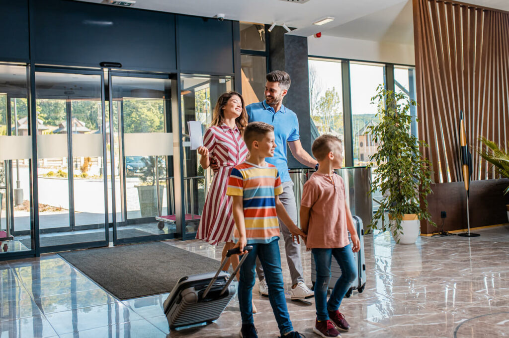 happy family walking into hotel