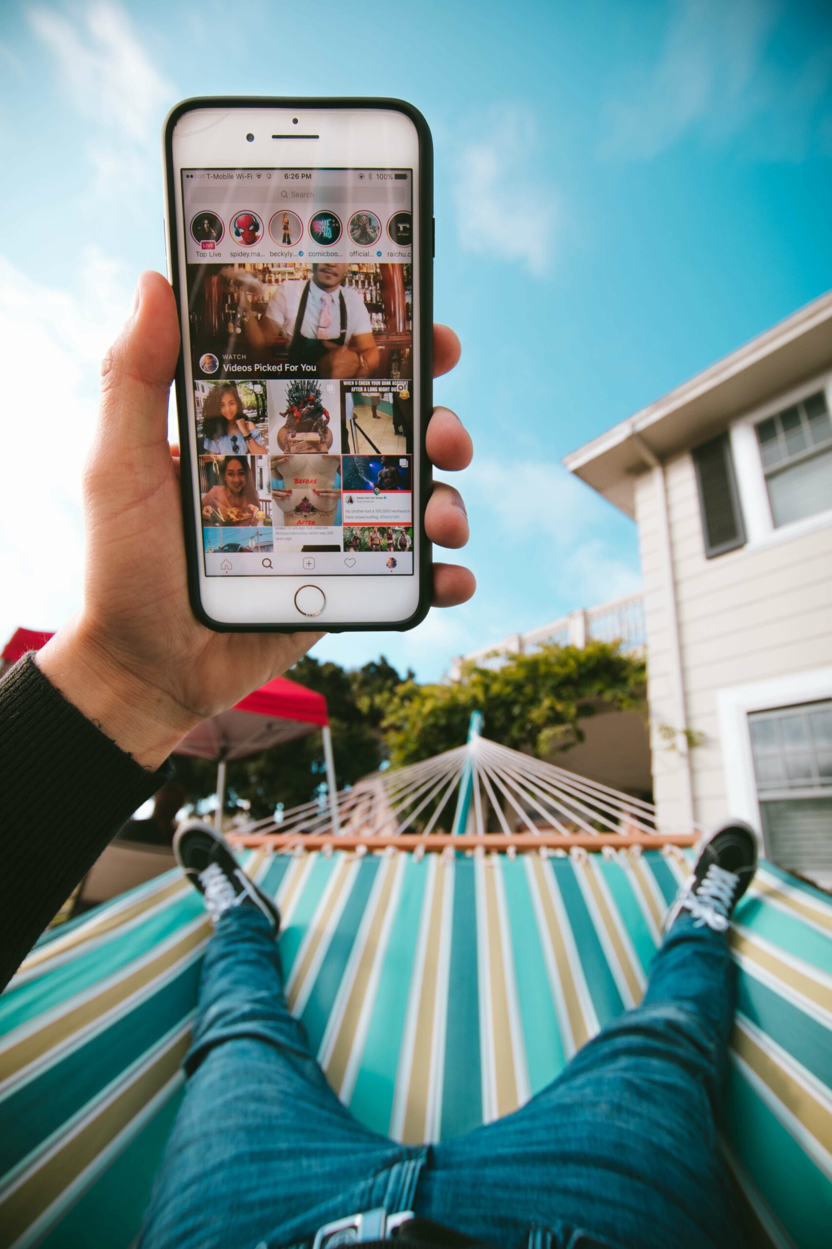 man on a swing looking at phone