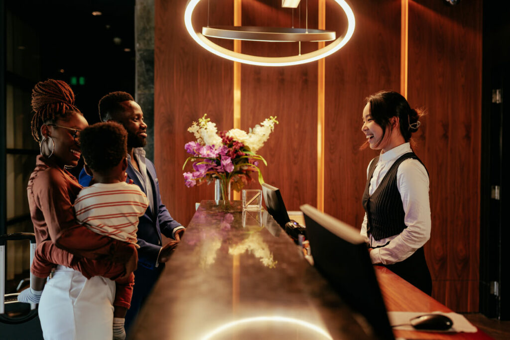 happy hotel receptionist welcoming happy family