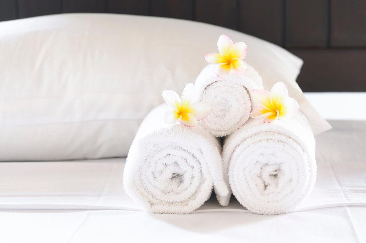 rolled towels on the bed