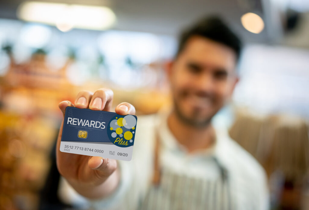 man holding loyalty program card