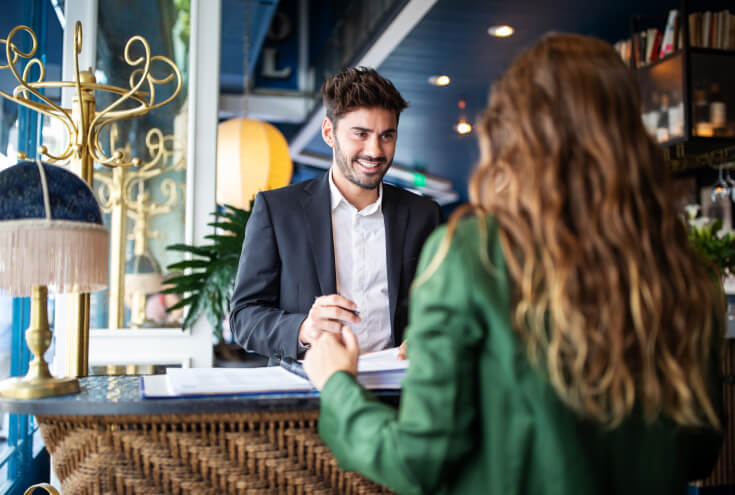 receptionist welcoming guest at hotel